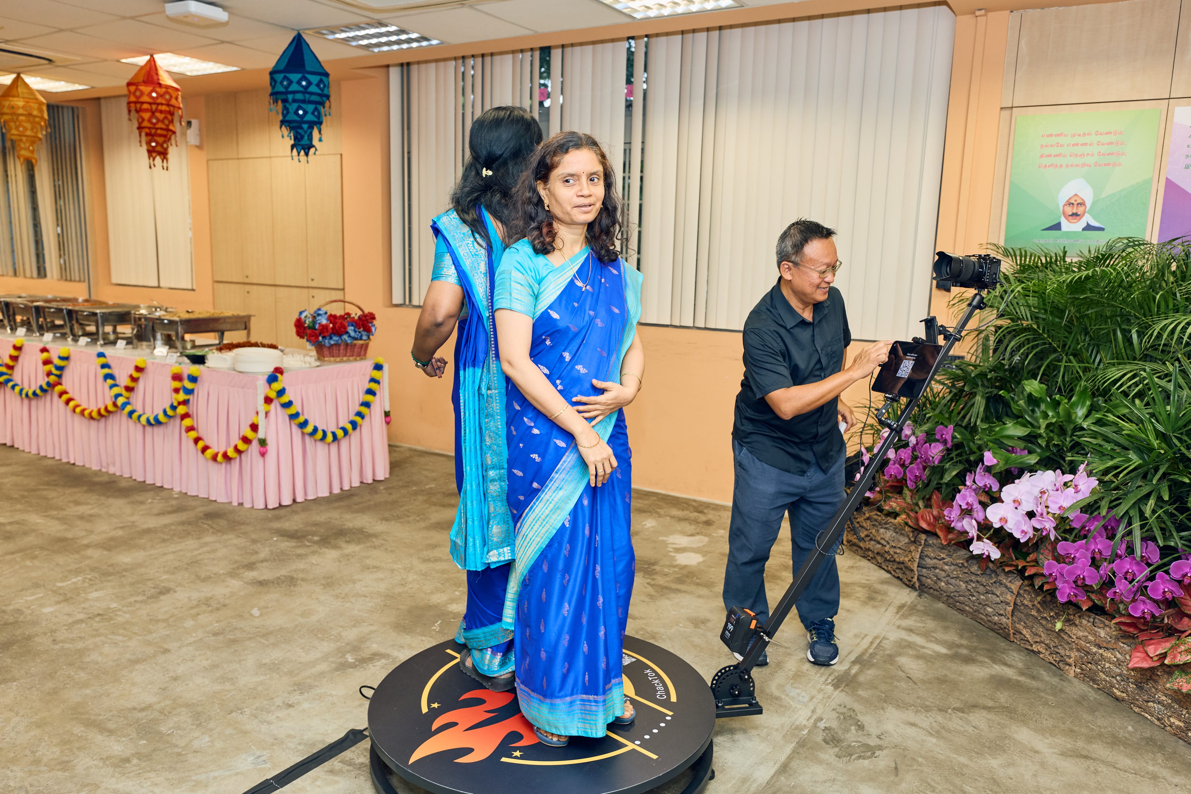 Parent trying the 360-degree video booth during a UPTLC event.